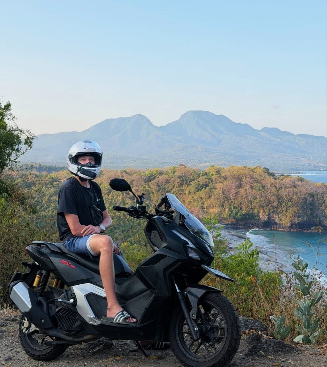 Guest on a Honda ADV overlooking the Bali coast
